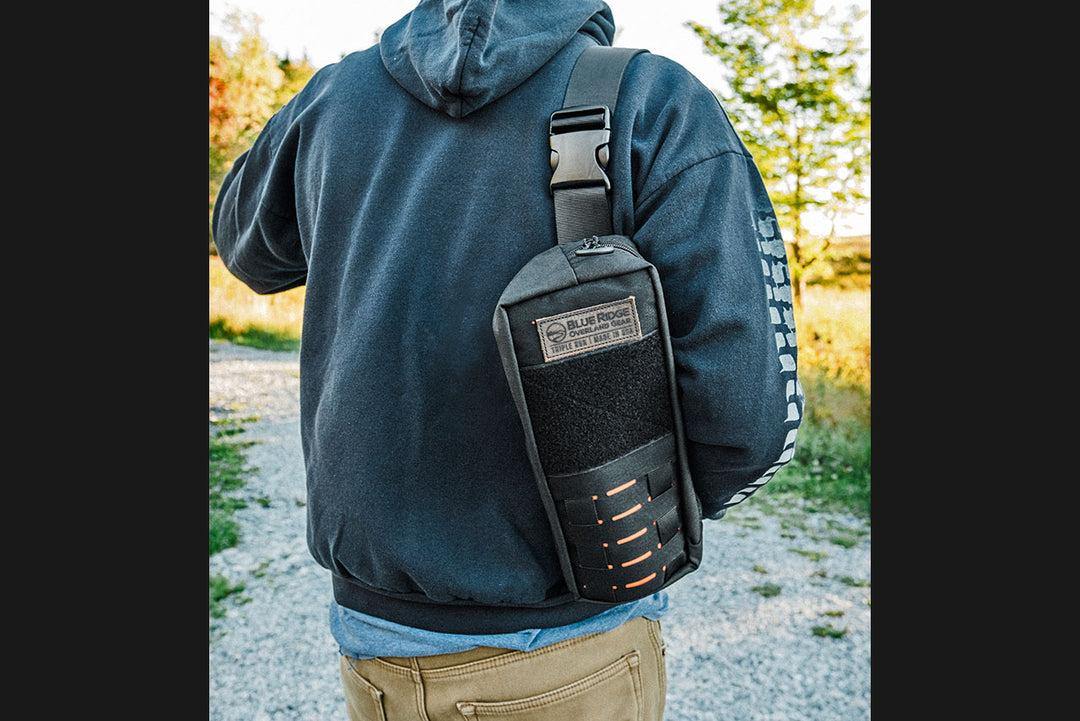 Bootlegger bourbon, whiskey bag - lifestyle image outdoors with man carrying bag over shoulder.