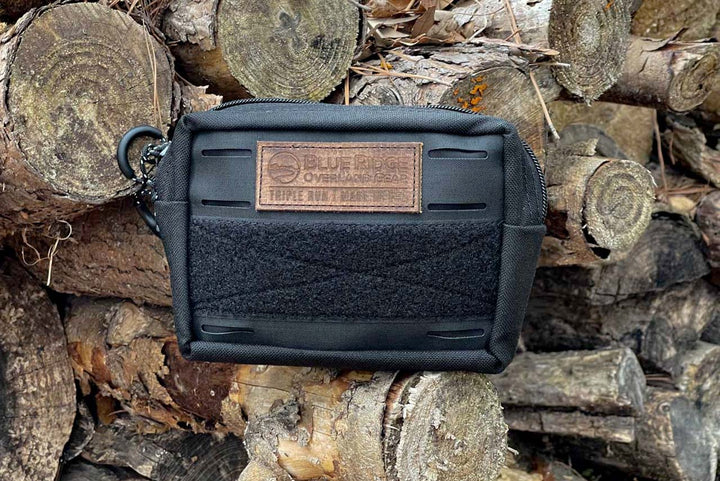 Black Bum Bag on a woodpile