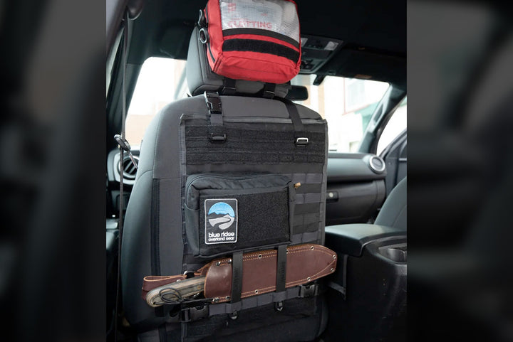 Seat back panel with black Medium GP Pouch, knife holster, and first aid kit bag (on headrest)