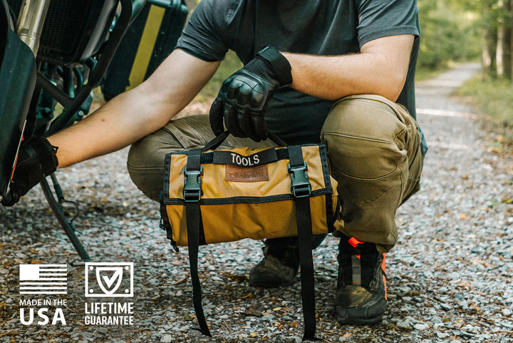 Man holding Tool Pouch Roll, tool roll with removable Velcro pouches by Blue Ridge Overland Gear. Perfect for off-road repairs, overlanding, and adventure motorcycle repairs on the trail.